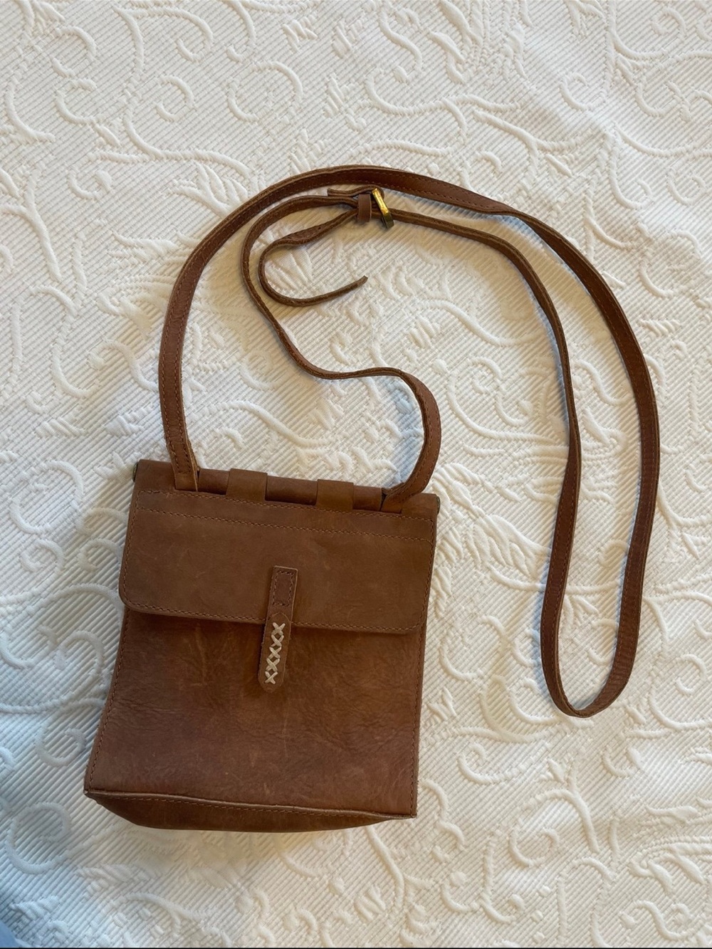 Compact Brown Leather Crossbody Bag with Flap and Stitched Tab